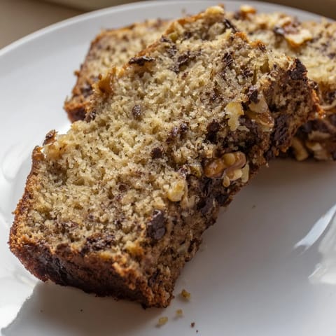 A freshly baked banana bread loaf with a golden crust and inviting aroma.