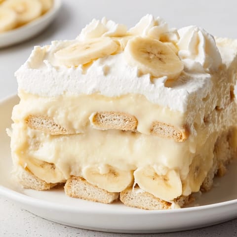Classic Southern banana pudding layered in a glass dish, inviting you to imagine the taste.