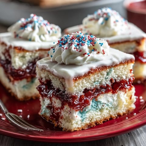 Festive Patriotic Poke Cake with white chocolate ganache, a star-spangled delight.