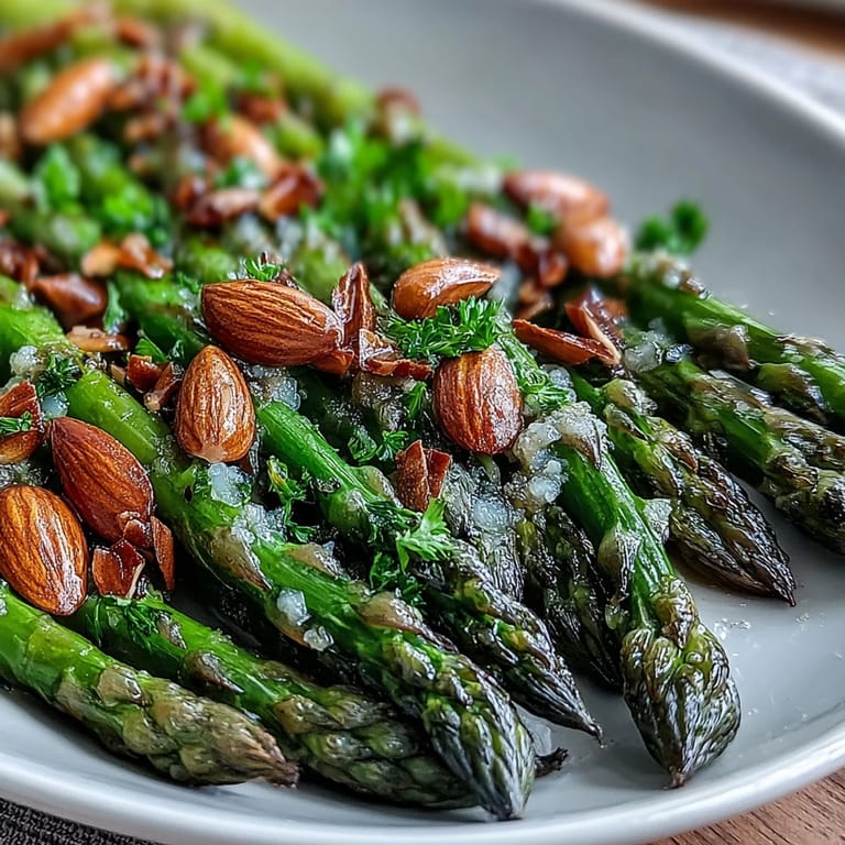 Crisp asparagus drizzled with lemon butter and sprinkled with toasted almonds offers a refreshing, gluten-free spring side.
