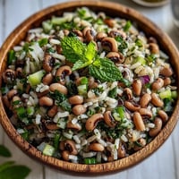 Bright bowl of Southern Black Eyed Pea Salad with brown rice, celery, and red onion.